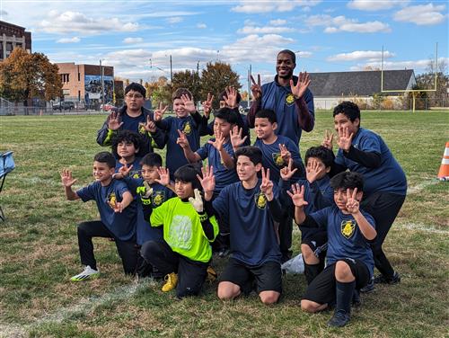 Student soccer players posing with 5 and 2 hands.